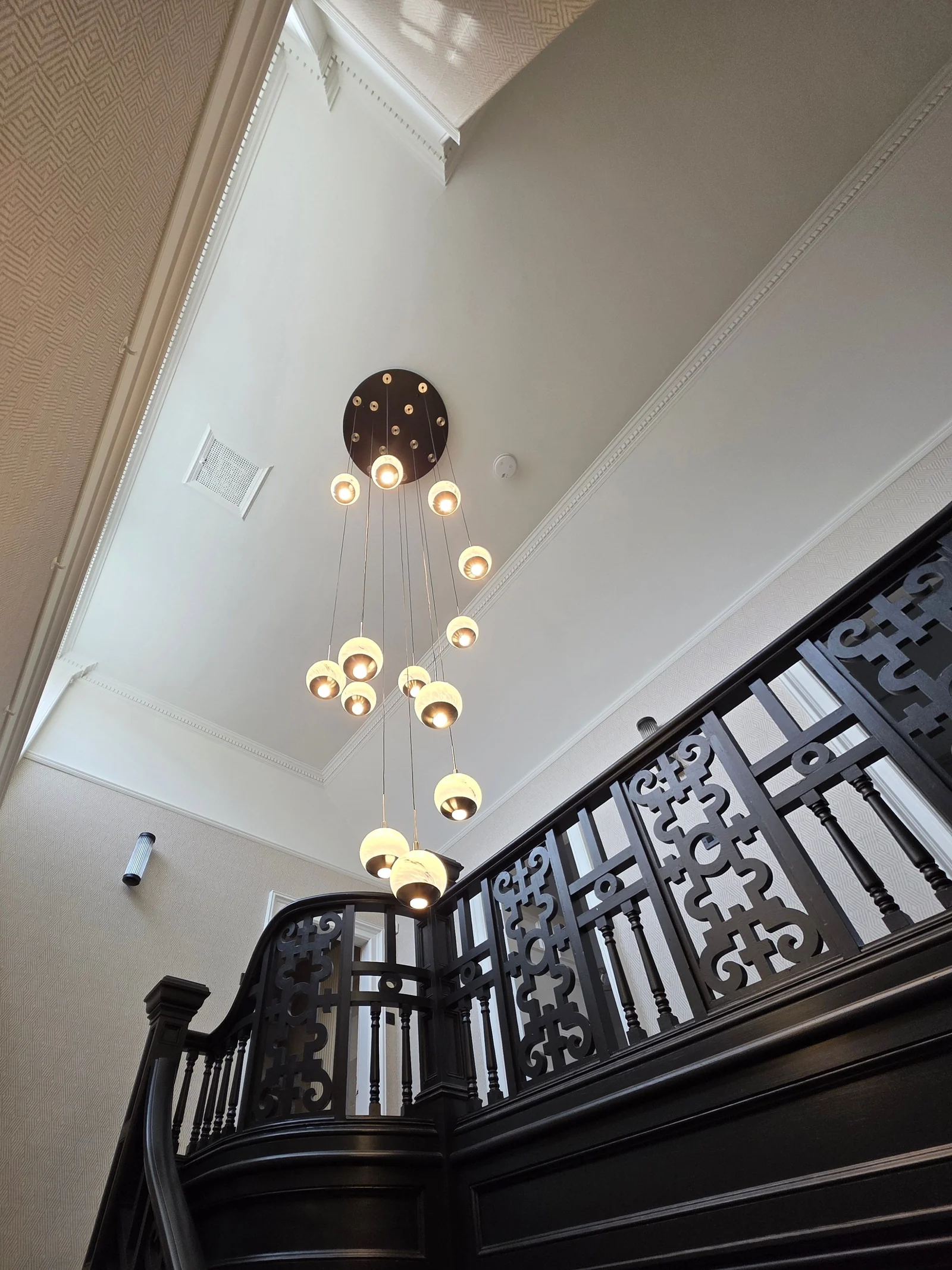 Multi-drop pendant chandelier installed over a period staircase in Edinburgh by Spartan Electrical